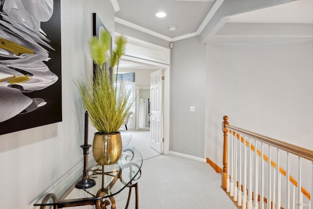 corridor featuring recessed lighting, light carpet, an upstairs landing, baseboards, and crown molding