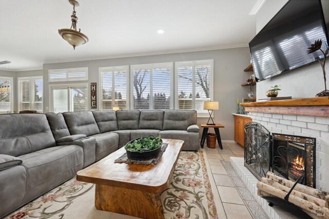 living room with crown molding, a brick fireplace, light tile patterned flooring, and baseboards