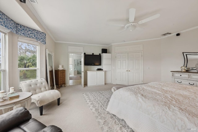 bedroom with a closet, light carpet, crown molding, and visible vents