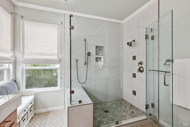 bathroom with a stall shower, baseboards, ornamental molding, and vanity