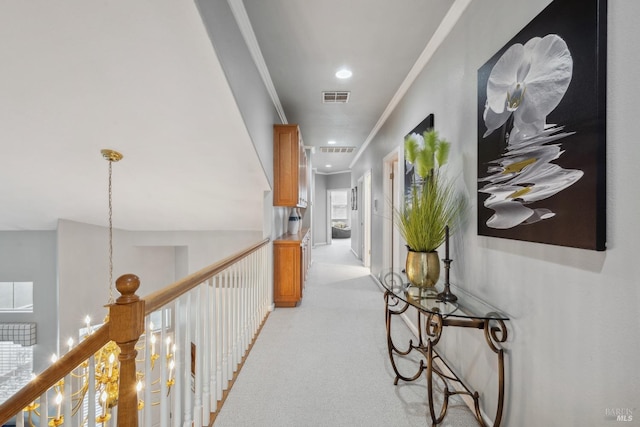 corridor with recessed lighting, light colored carpet, crown molding, and visible vents