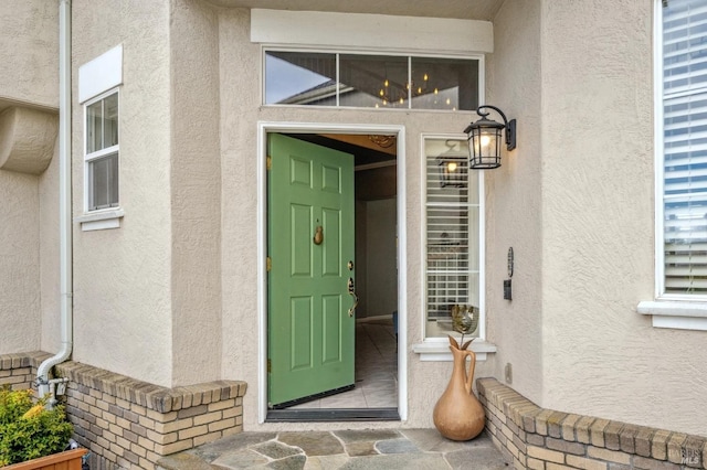 doorway to property with stucco siding