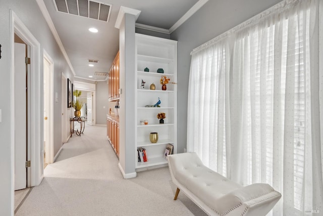 corridor featuring recessed lighting, light colored carpet, visible vents, baseboards, and ornamental molding