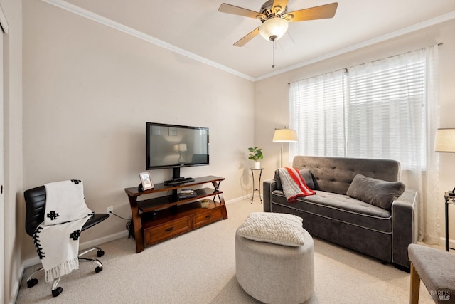 carpeted living area featuring ornamental molding, ceiling fan, and baseboards