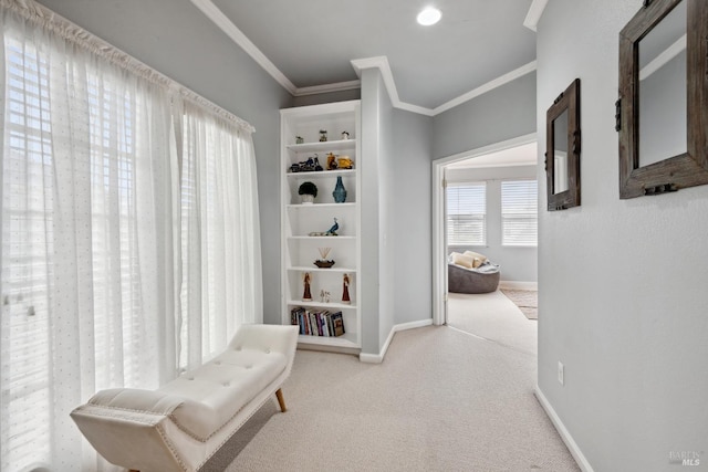 sitting room featuring baseboards, ornamental molding, and carpet flooring