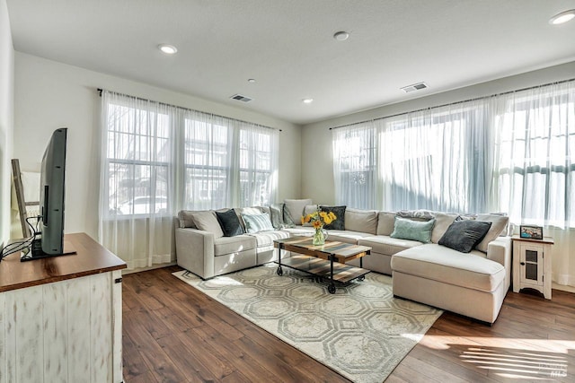 living room featuring recessed lighting, visible vents, a healthy amount of sunlight, and hardwood / wood-style floors