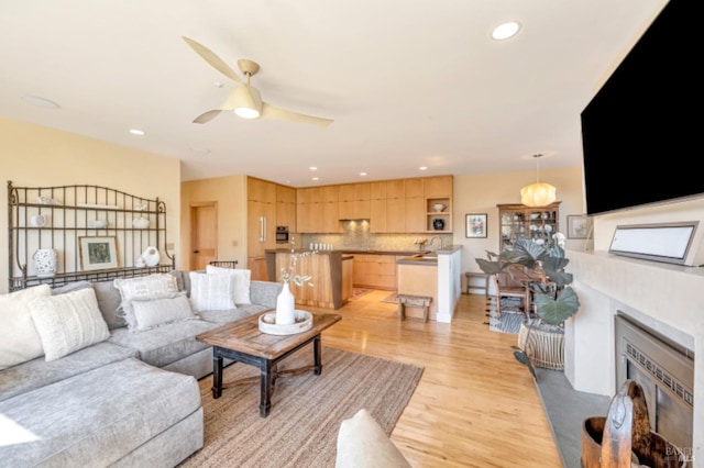 7 Highland Ave, San Rafael, CA 94901 - living area featuring recessed lighting, light wood-style flooring, a glass covered fireplace, and a ceiling fan