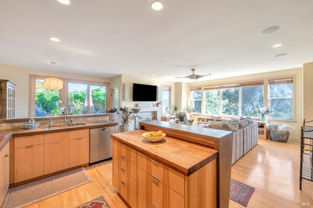 7 Highland Ave, San Rafael, CA 94901 - kitchen featuring butcher block countertops, light wood finished floors, dishwasher, a sink, and light brown cabinetry