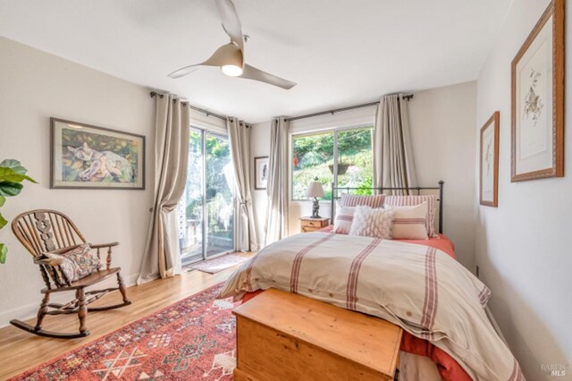 7 Highland Ave, San Rafael, CA 94901 - bedroom with multiple windows, access to exterior, and wood finished floors