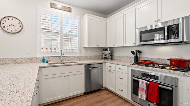 1623 Winterberry Ln, Rohnert Park, CA 94928 - kitchen with appliances with stainless steel finishes, a sink, white cabinets, and light wood finished floors
