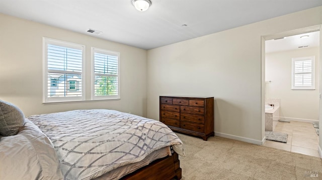 1623 Winterberry Ln, Rohnert Park, CA 94928 - carpeted bedroom with multiple windows, baseboards, tile patterned floors, and connected bathroom