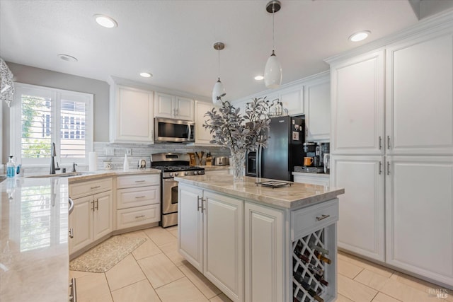 kitchen with stainless steel appliances, white cabinets, a kitchen island, and hanging light fixtures