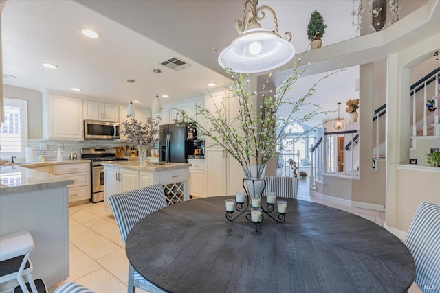 dining space featuring recessed lighting, stairs, visible vents, and light tile patterned flooring