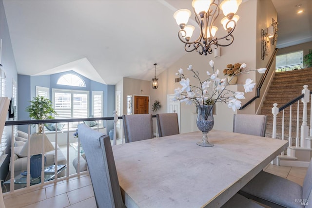 dining area featuring light tile patterned floors, stairs, vaulted ceiling, and an inviting chandelier