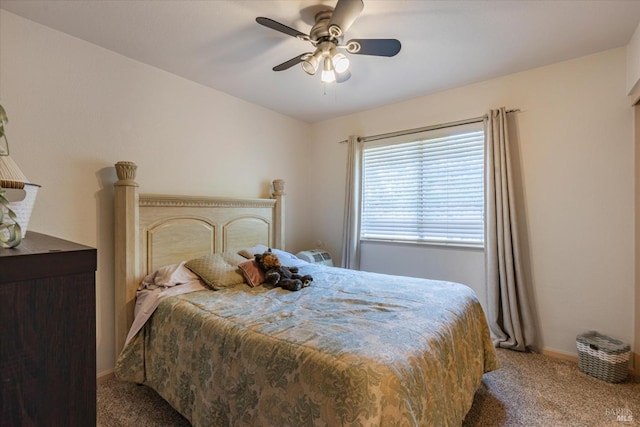 carpeted bedroom featuring a ceiling fan and baseboards