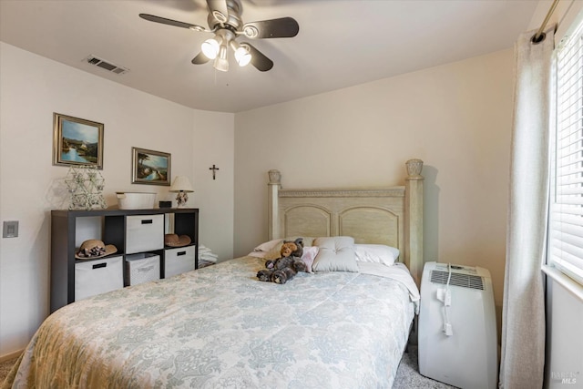 bedroom with visible vents and a ceiling fan