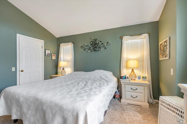 bedroom with vaulted ceiling and light carpet