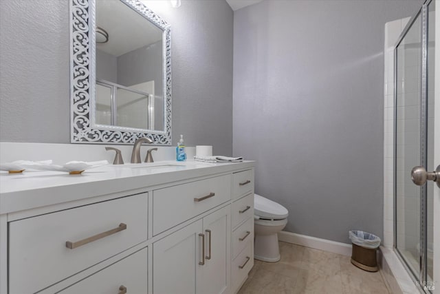 full bathroom with a stall shower, vanity, toilet, and baseboards