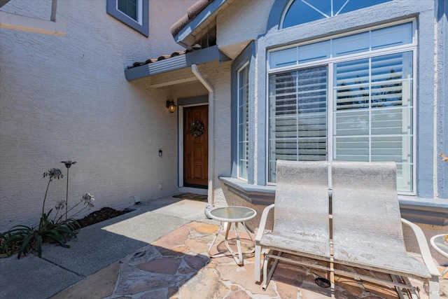 entrance to property with stucco siding