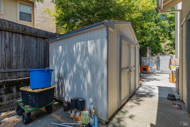 view of shed featuring fence