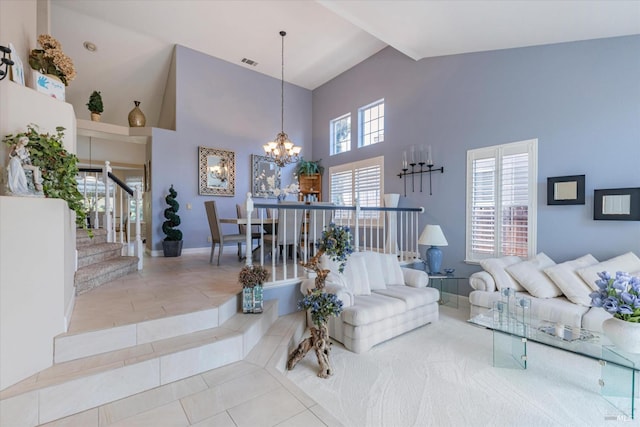 living area with high vaulted ceiling, light tile patterned flooring, visible vents, stairs, and an inviting chandelier