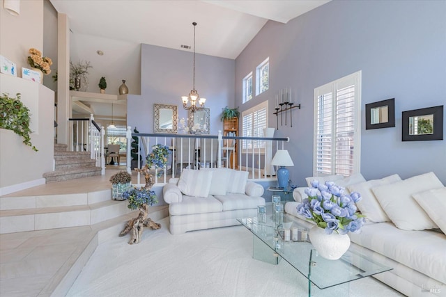 living room featuring a chandelier, tile patterned flooring, a towering ceiling, and stairs