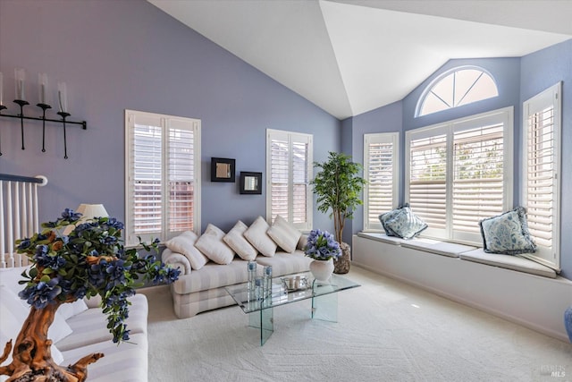 carpeted living room with a wealth of natural light and lofted ceiling