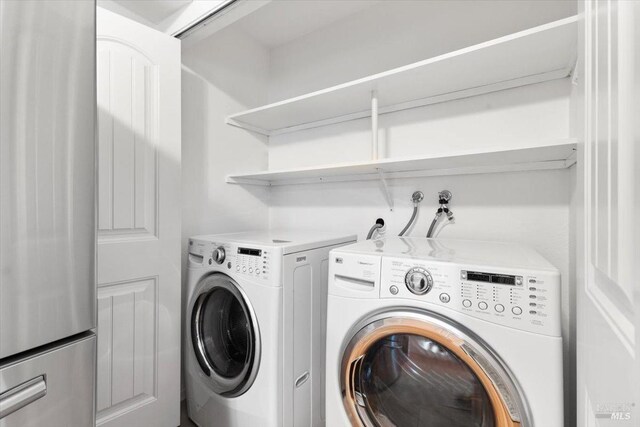 washroom featuring laundry area and washer and dryer