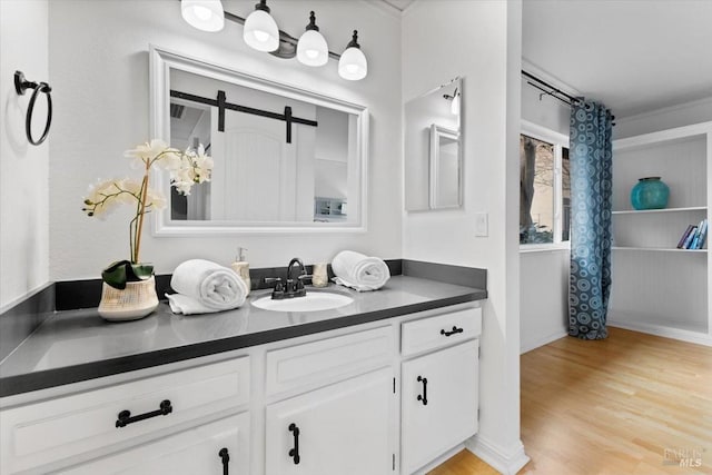 bedroom featuring baseboards, visible vents, and wood finished floors