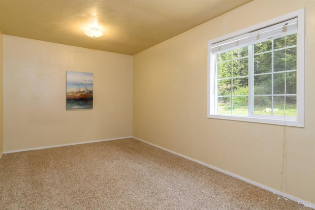 carpeted empty room with baseboards