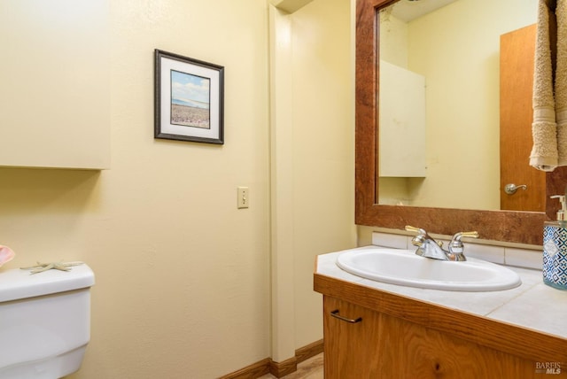 half bathroom with toilet and vanity