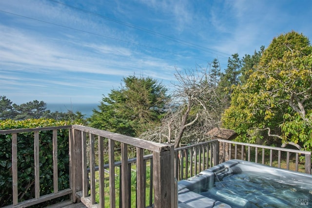 wooden deck featuring a hot tub