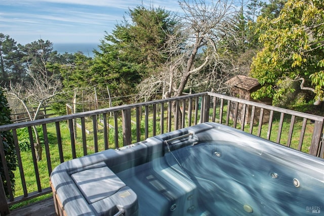 wooden deck featuring a hot tub