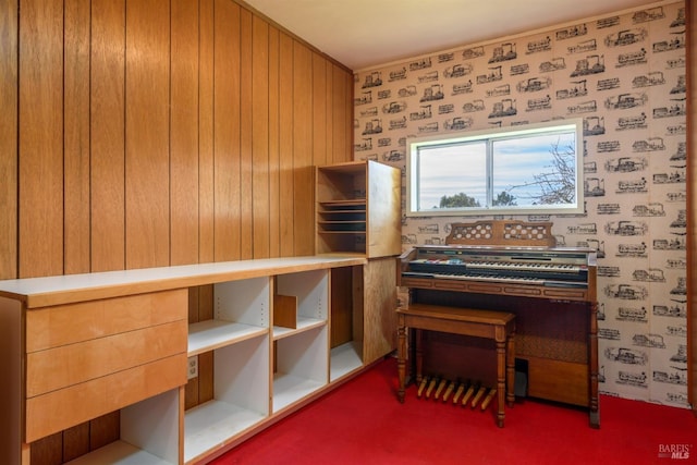 interior space with carpet and wallpapered walls