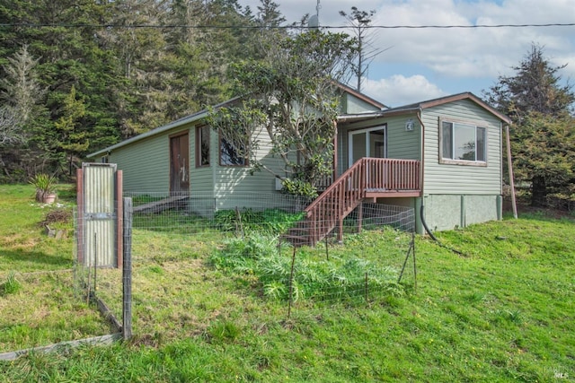 view of front of property with fence, stairway, and a front yard