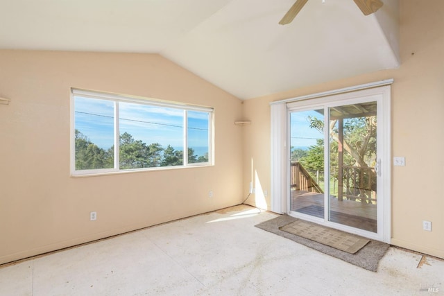 spare room with vaulted ceiling, a ceiling fan, and baseboards