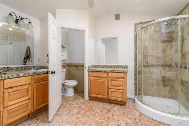 bathroom featuring a stall shower, visible vents, lofted ceiling, and toilet