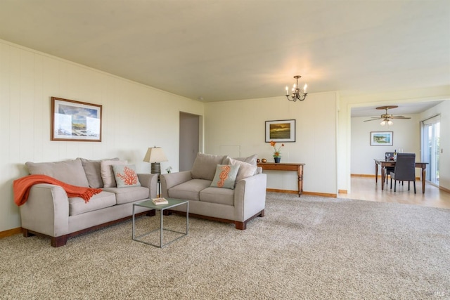 living room with light carpet, baseboards, and a notable chandelier