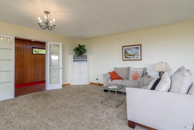 carpeted living area featuring an inviting chandelier