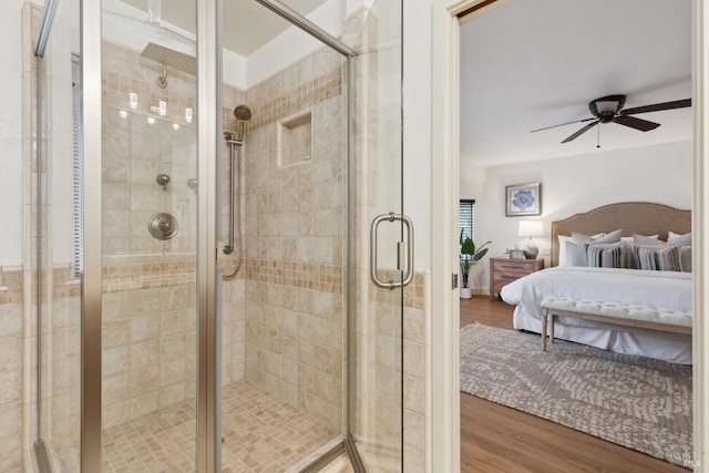 ensuite bathroom with wood finished floors, ensuite bath, a ceiling fan, and a shower stall