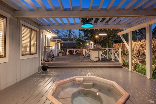 wooden deck featuring a pergola and hot tub deck surround