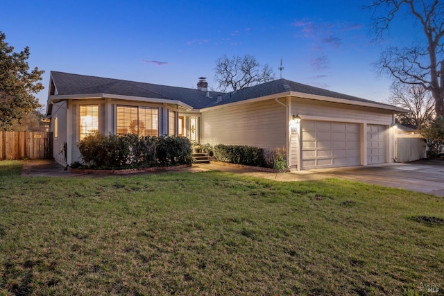 ranch-style home featuring concrete driveway, a chimney, a front yard, and fence