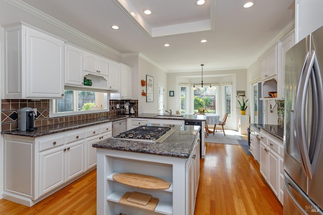 kitchen featuring appliances with stainless steel finishes, a peninsula, light wood-style floors, white cabinetry, and open shelves