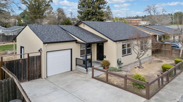 single story home featuring stucco siding, driveway, fence, a shingled roof, and a garage