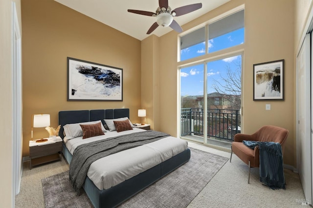 bedroom featuring carpet floors, a ceiling fan, baseboards, and access to outside