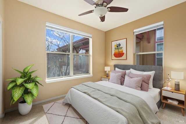 bedroom with baseboards, ceiling fan, and carpet flooring