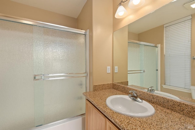 bathroom featuring enclosed tub / shower combo and vanity