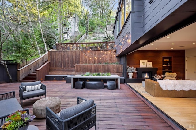 wooden deck with fence, an outdoor living space, and stairs