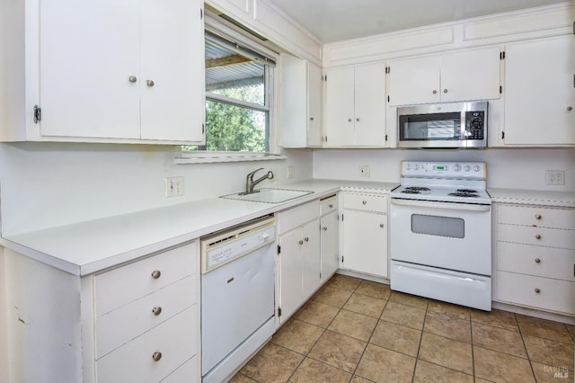 kitchen featuring light countertops, white appliances, a sink, and white cabinets