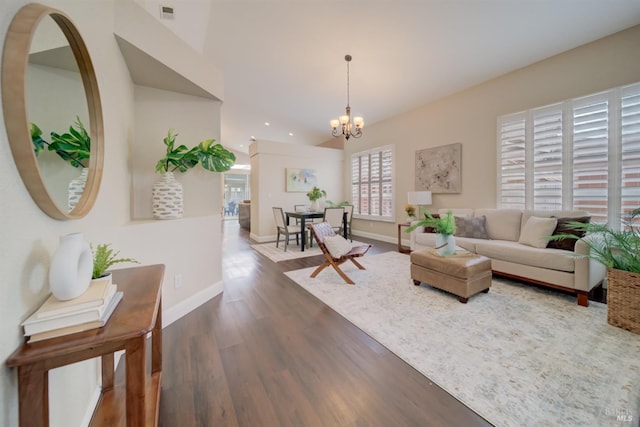 living area with a notable chandelier, dark wood finished floors, recessed lighting, visible vents, and baseboards